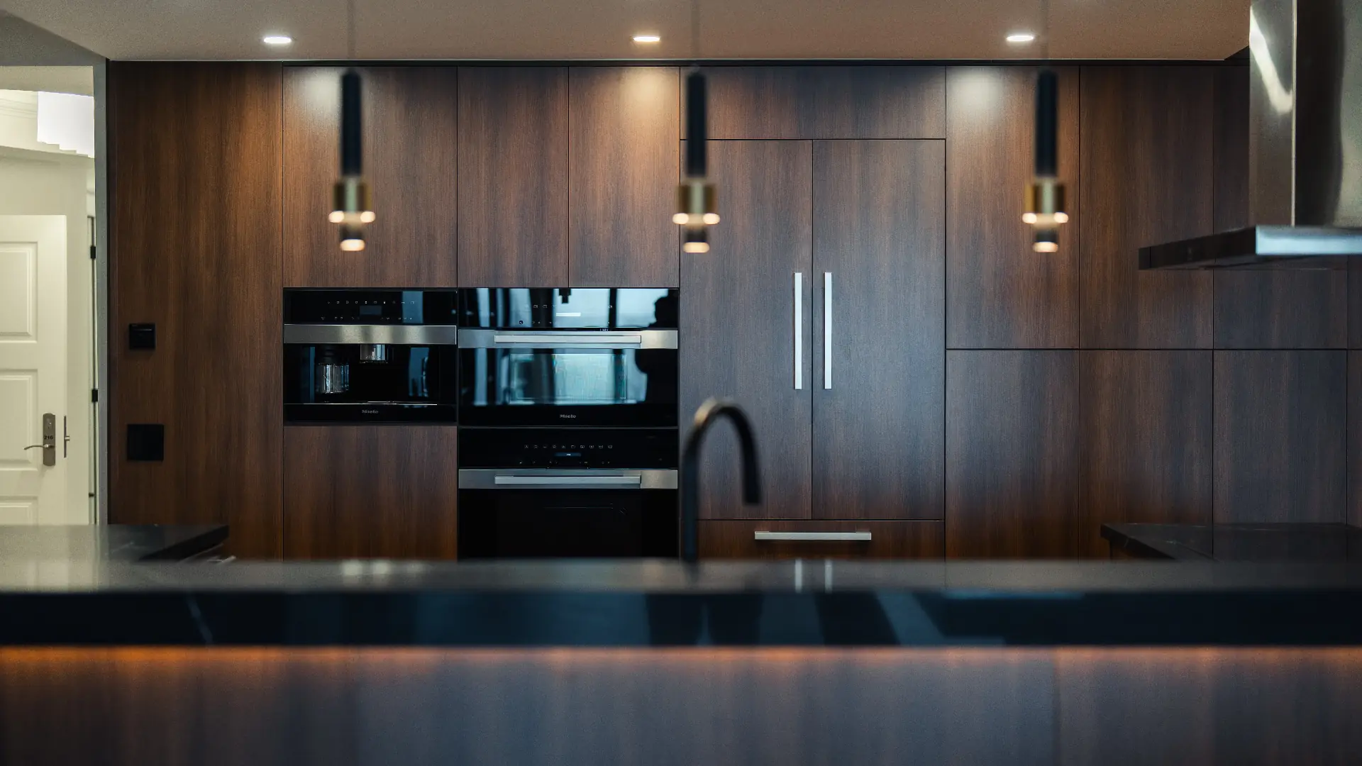 Floor-to-ceiling walnut kitchen by Teak International